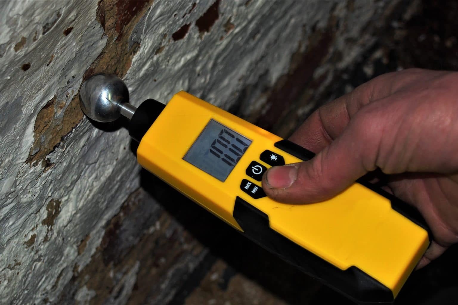 Moisture meter being used to verify drying progress
